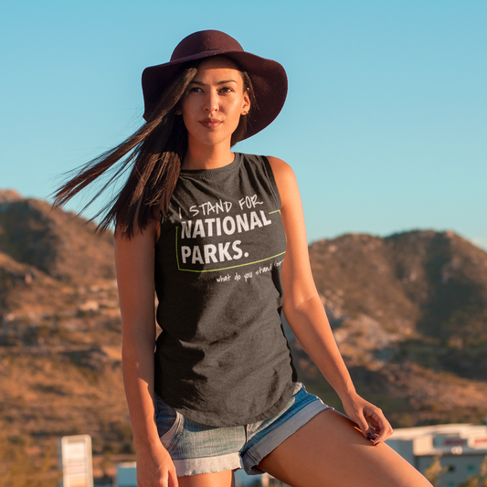 Woman wearing a 'Stand for National Parks' shirt with mountains in the background