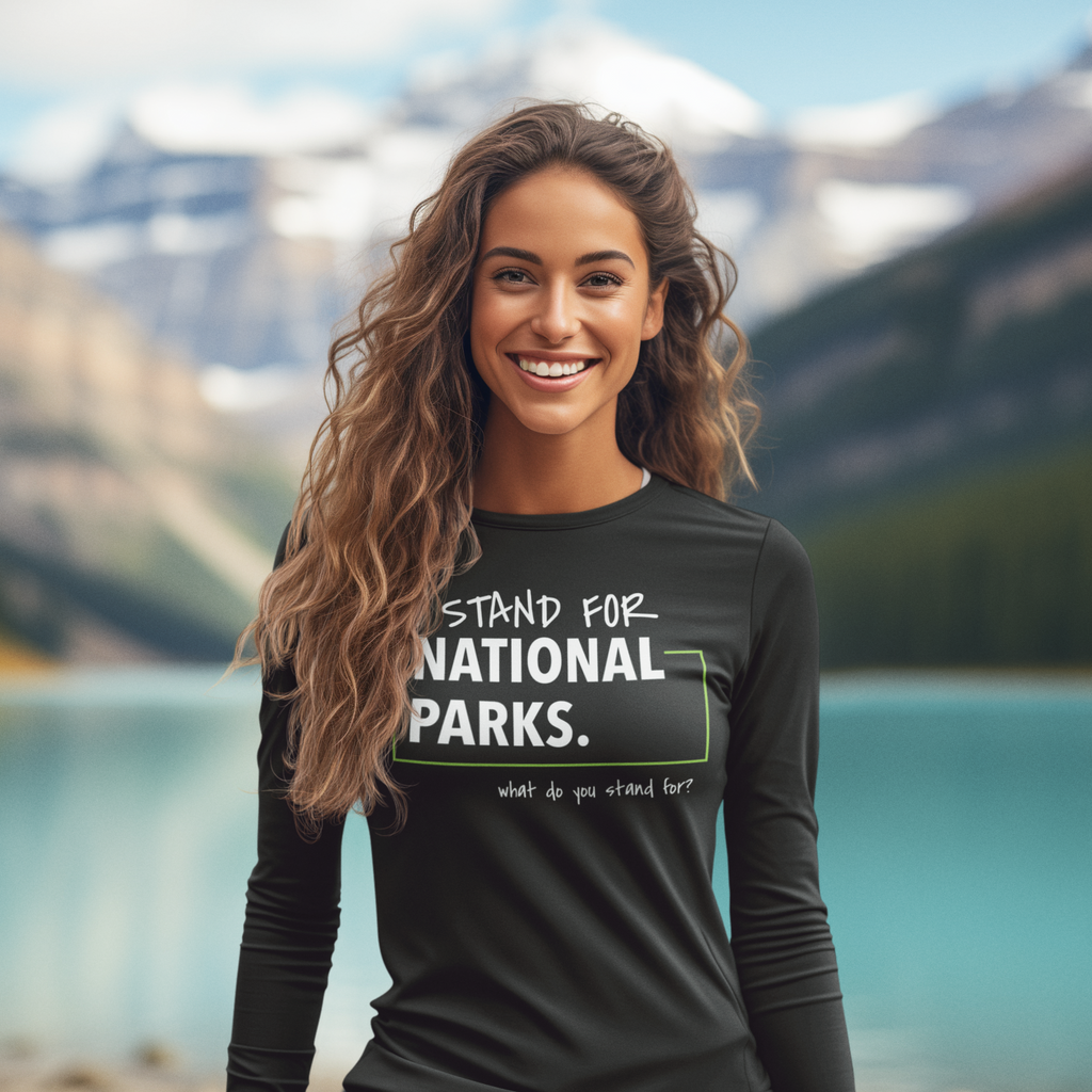 Woman wearing a 'Stand for National Parks' shirt with a scenic background of mountains and water.