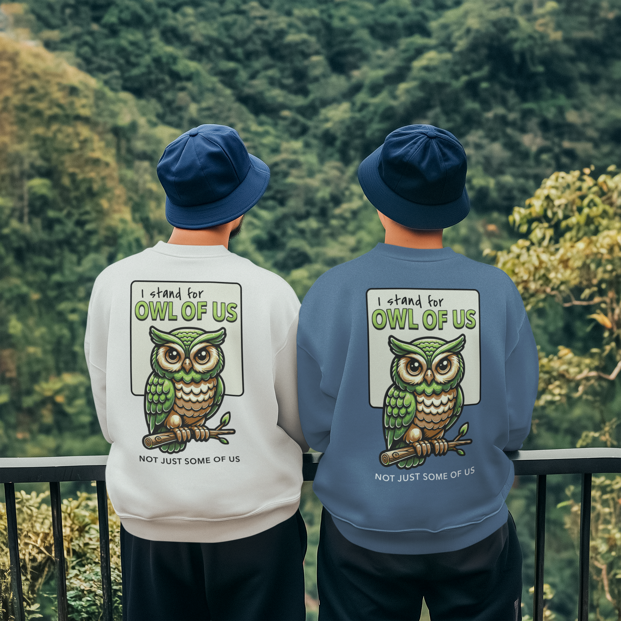 Two people wearing sweatshirts with an owl design and text, standing against a forest background.